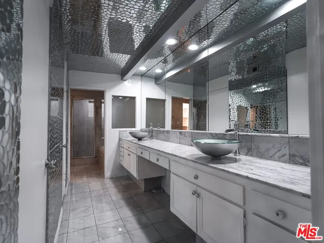 a kitchen with a sink a microwave and cabinets