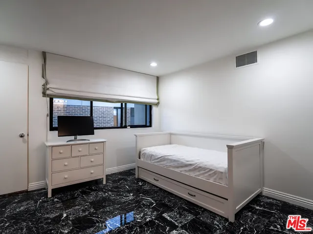 a room with a bed and a television