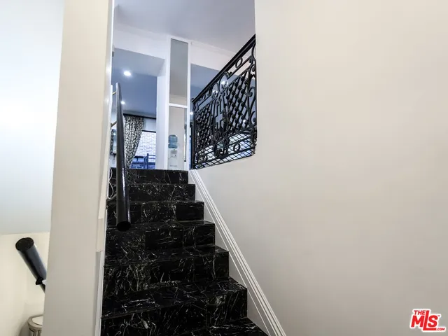 a spacious bedroom with a bed and window