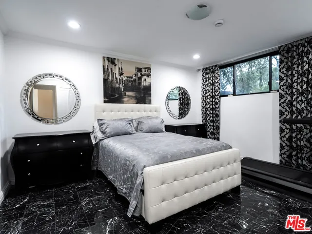 a bedroom with furniture and a window