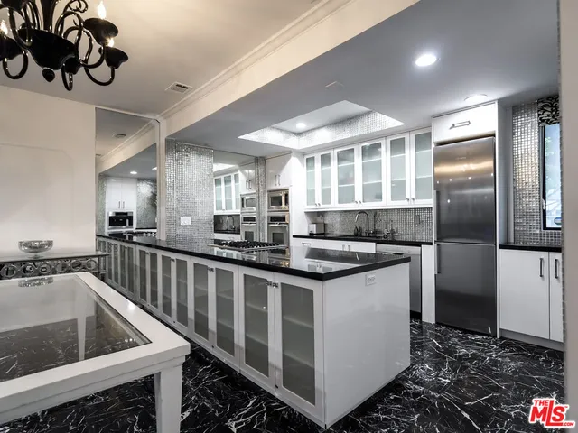 a kitchen with stainless steel appliances granite countertop a sink and a stove