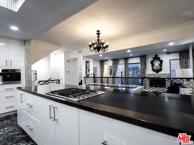 a kitchen with a counter space a stove and cabinets