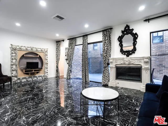 a living room with furniture a fireplace and a table