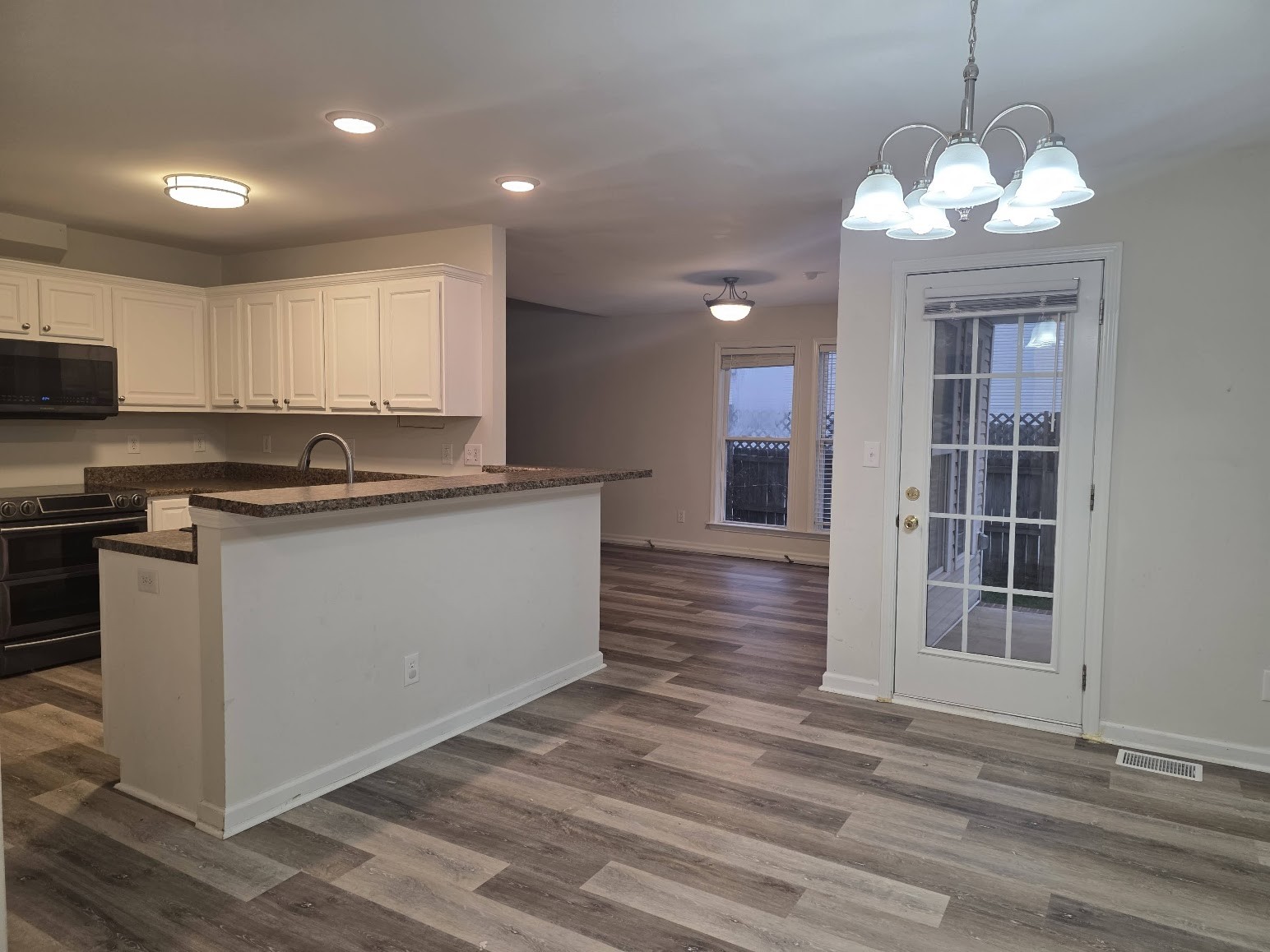 1556 Tylertown Road Clarksville, TN 37040 - Photo 5 of 10 a kitchen with kitchen island granite countertop a sink cabinets and stainless steel appliances