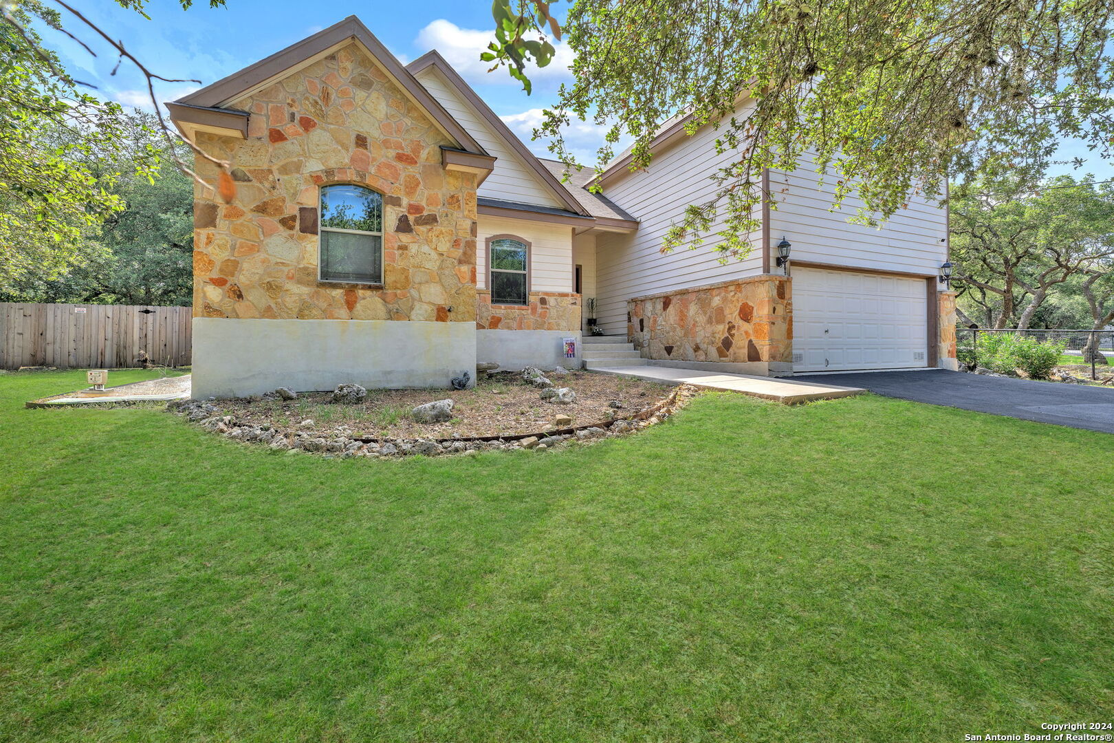 a front view of a house with a garden and yard