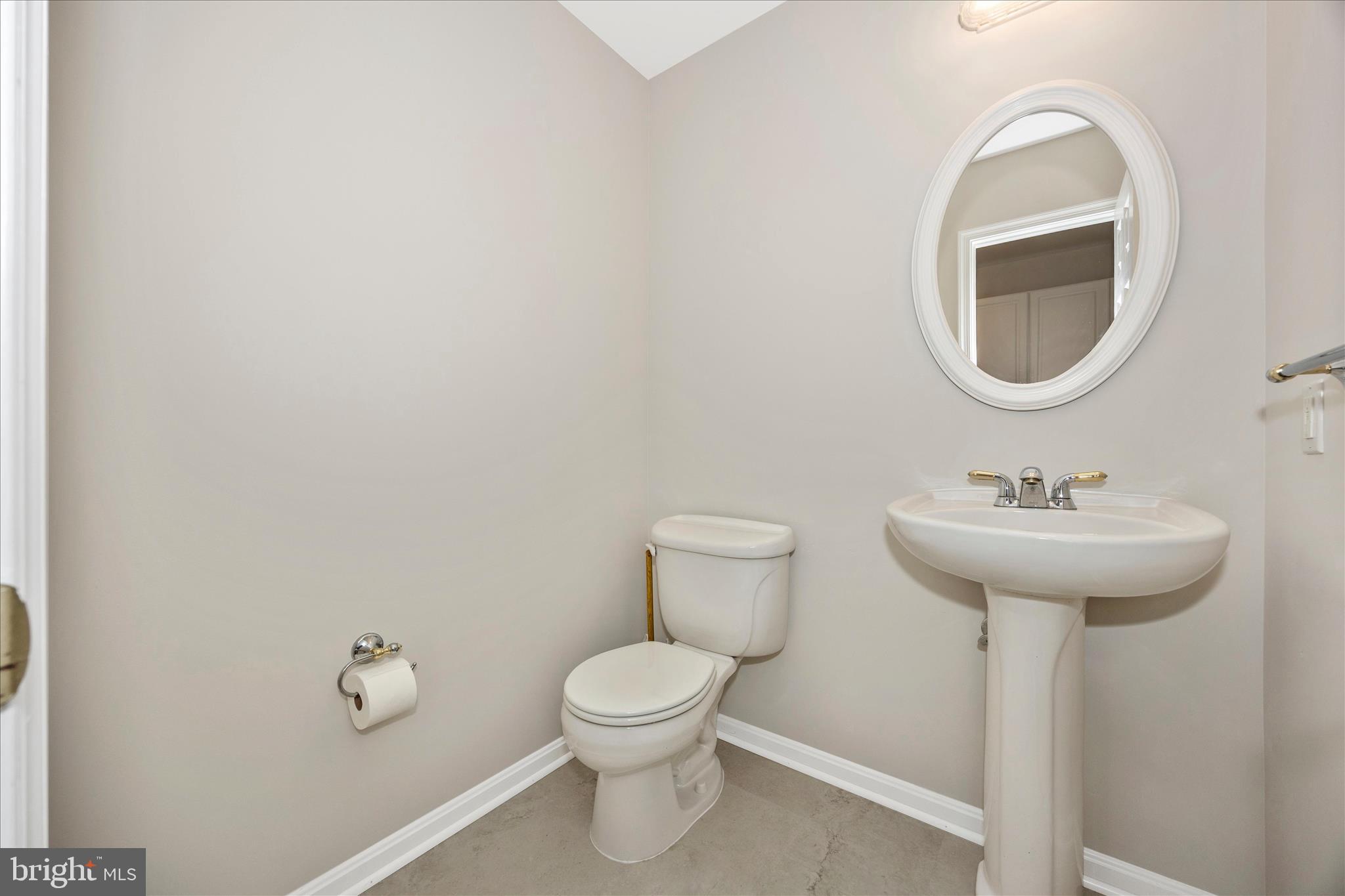 10393 Liberty Road Frederick, MD 21701 - Photo 27 of 47 a bathroom with a toilet sink and mirror