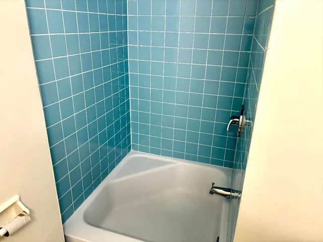 a bathroom with a blue tub
