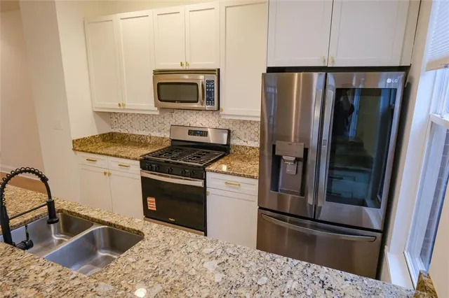 a kitchen with a refrigerator sink and microwave