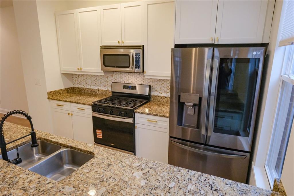 6001 Brookside Oak Circle Norcross, GA 30093 - Photo 12 of 40 a kitchen with a refrigerator sink and microwave