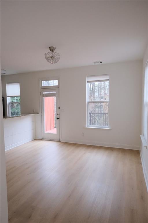 6001 Brookside Oak Circle Norcross, GA 30093 - Photo 15 of 40 an empty room with windows and chandelier fan