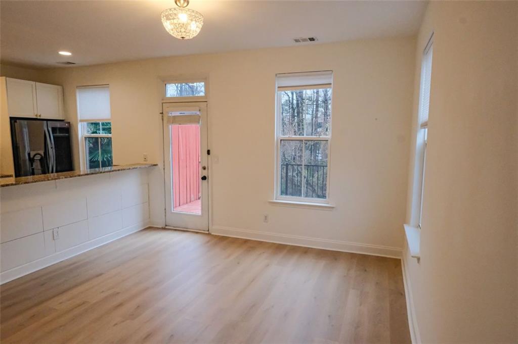 6001 Brookside Oak Circle Norcross, GA 30093 - Photo 16 of 40 wooden floor in an empty room with a window