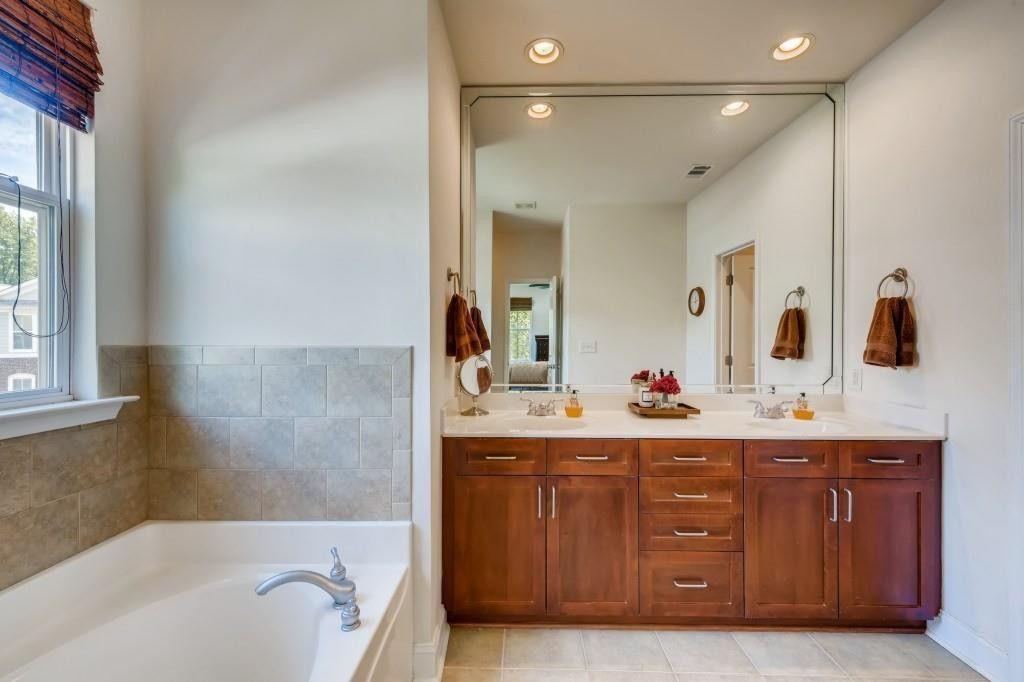 6001 Brookside Oak Circle Norcross, GA 30093 - Photo 17 of 40 a bathroom with a tub sink and mirror