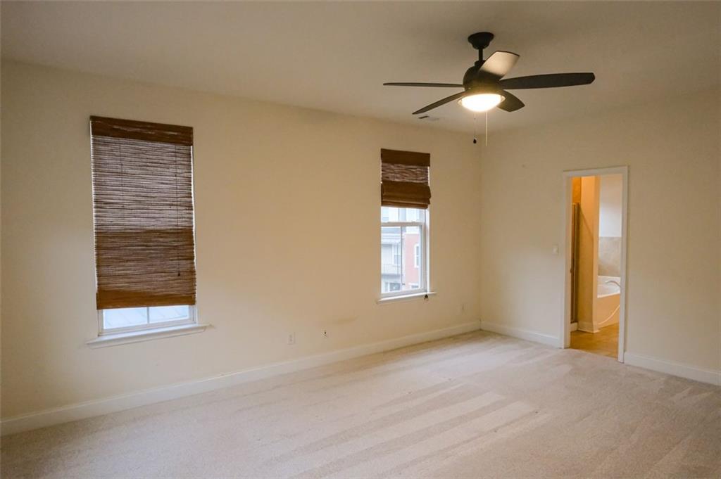6001 Brookside Oak Circle Norcross, GA 30093 - Photo 22 of 40 a view of livingroom with window ceiling fan and hardwood floor