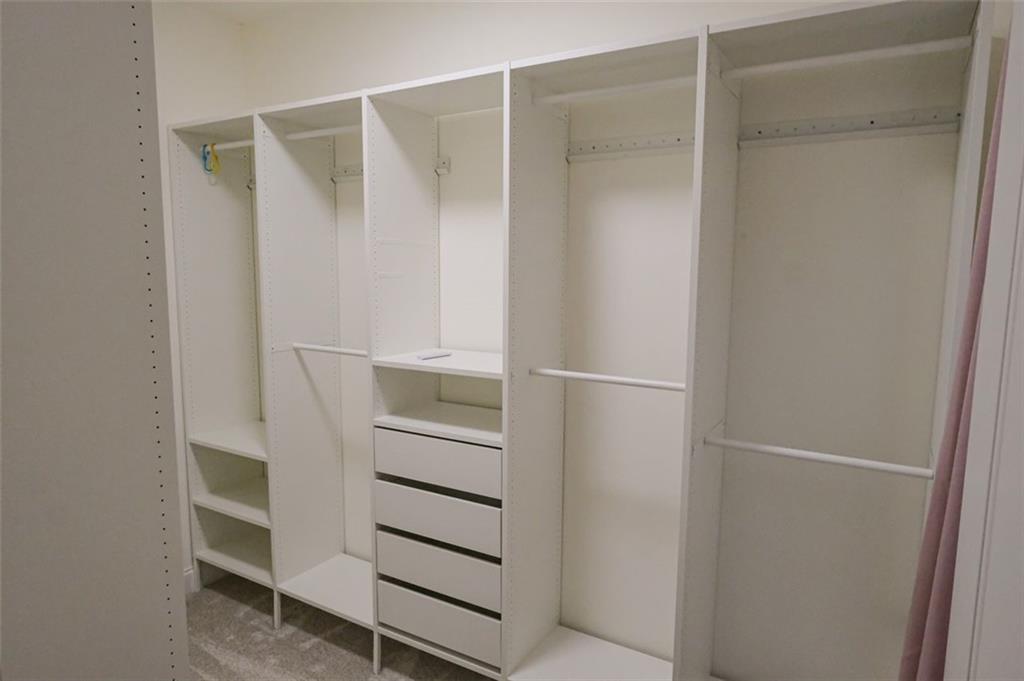 6001 Brookside Oak Circle Norcross, GA 30093 - Photo 25 of 40 a view of walk in closet with empty racks