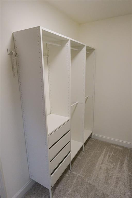 6001 Brookside Oak Circle Norcross, GA 30093 - Photo 27 of 40 a view of walk in closet with empty racks