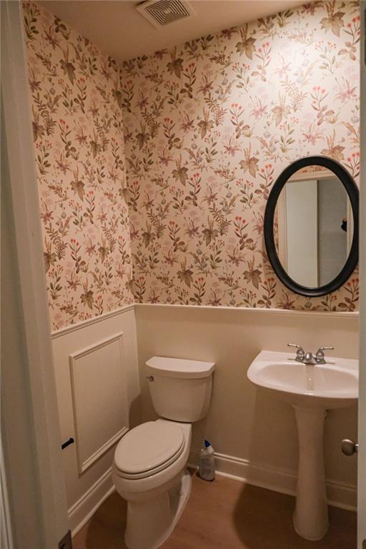 6001 Brookside Oak Circle Norcross, GA 30093 - Photo 31 of 40 a bathroom with a toilet sink and mirror
