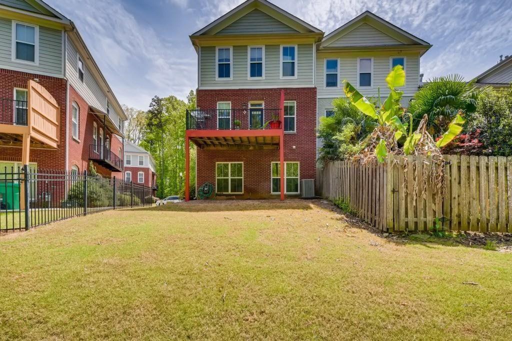 6001 Brookside Oak Circle Norcross, GA 30093 - Photo 38 of 40 a view of a brick house next to a yard with plants and trees
