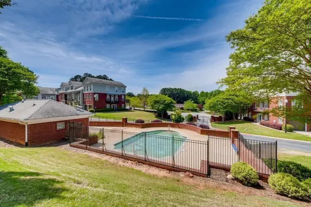 a view of a house with swimming pool and a yard