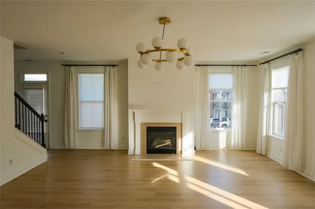 a view of an empty room with a fireplace and a window