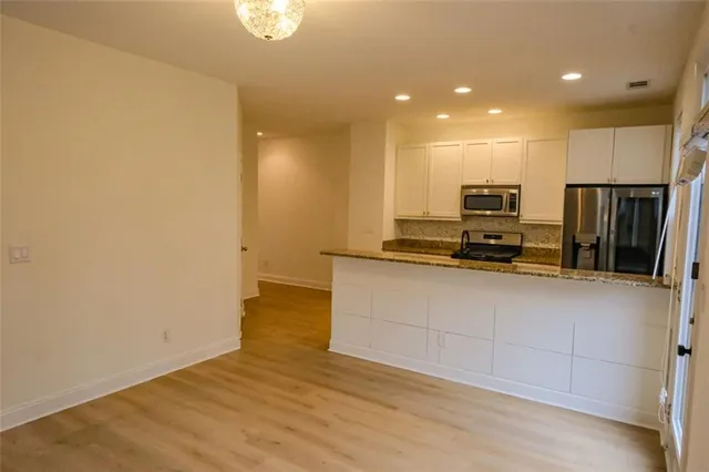 a view of kitchen with wooden floor