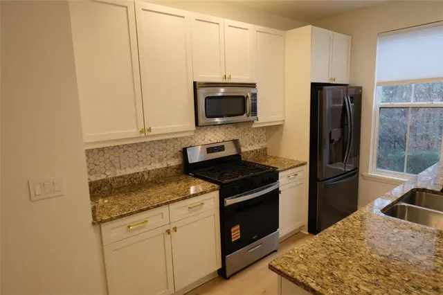 a kitchen with a stove microwave and refrigerator