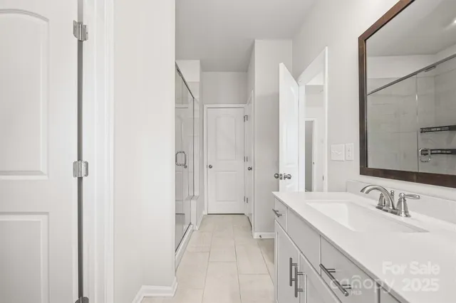 a spacious bathroom with a double vanity sink and a mirror