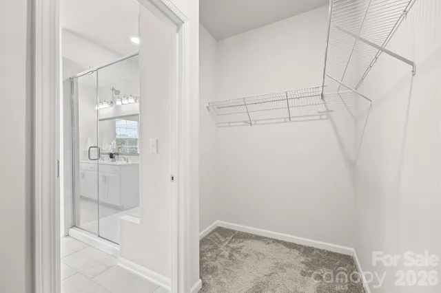 a spacious bathroom with a toilet sink and mirror