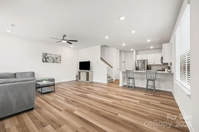 a living room with furniture and kitchen view