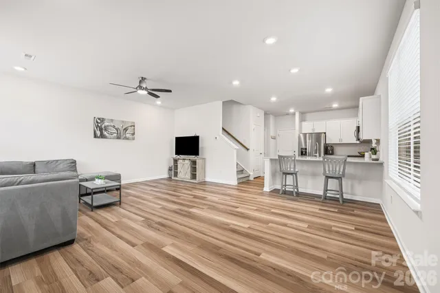 a living room with furniture and kitchen view