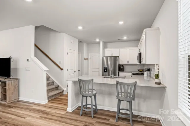 a view of kitchen with furniture and wooden floor