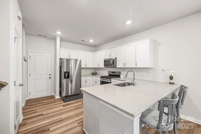 a kitchen with stainless steel appliances a refrigerator sink and cabinets