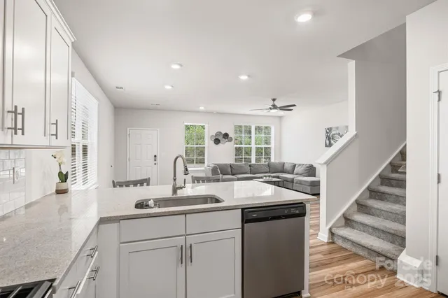 a kitchen with sink and view living room
