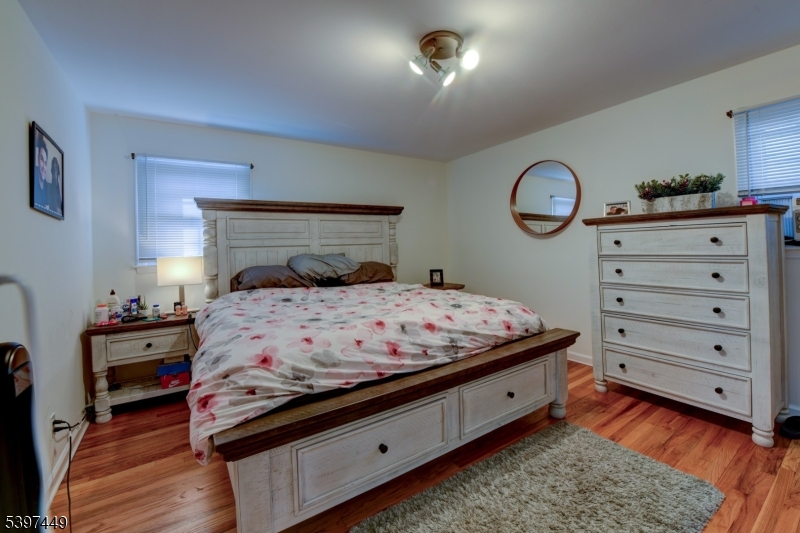 8 Sailer Court Elizabeth, NJ 07201 - Photo 11 of 27 a bedroom with a bed and a lamp on dresser