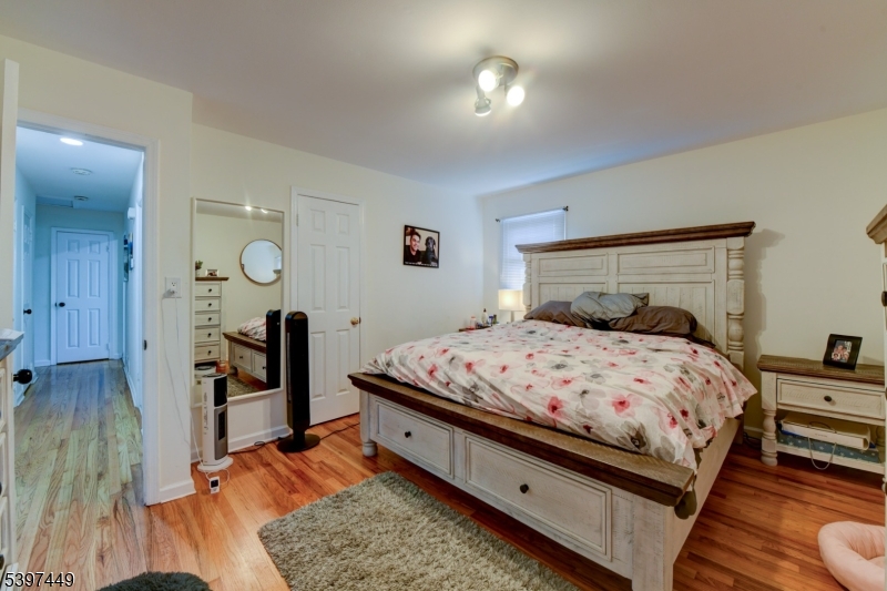 8 Sailer Court Elizabeth, NJ 07201 - Photo 12 of 27 a bedroom with a bed and wooden floor