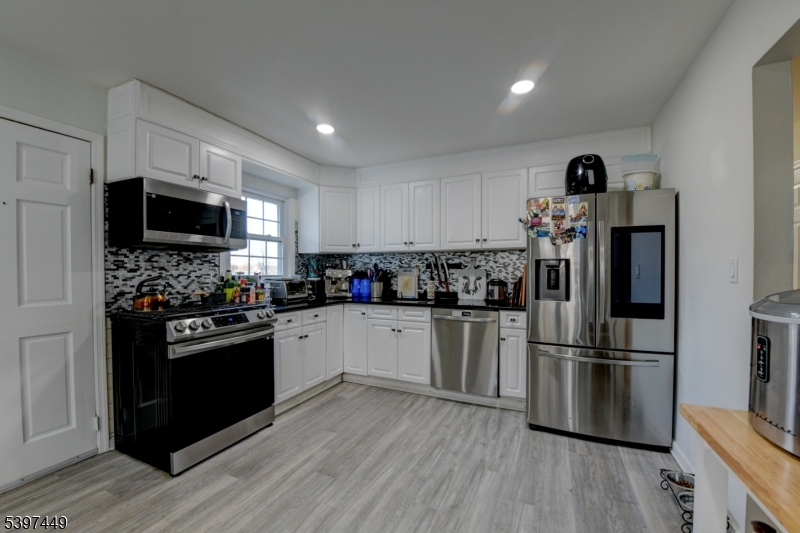 8 Sailer Court Elizabeth, NJ 07201 - Photo 14 of 27 a kitchen with a refrigerator and a stove top oven