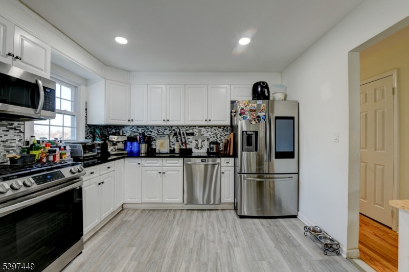 8 Sailer Court Elizabeth, NJ 07201 - Photo 15 of 27 a kitchen with granite countertop a refrigerator stove top oven and sink