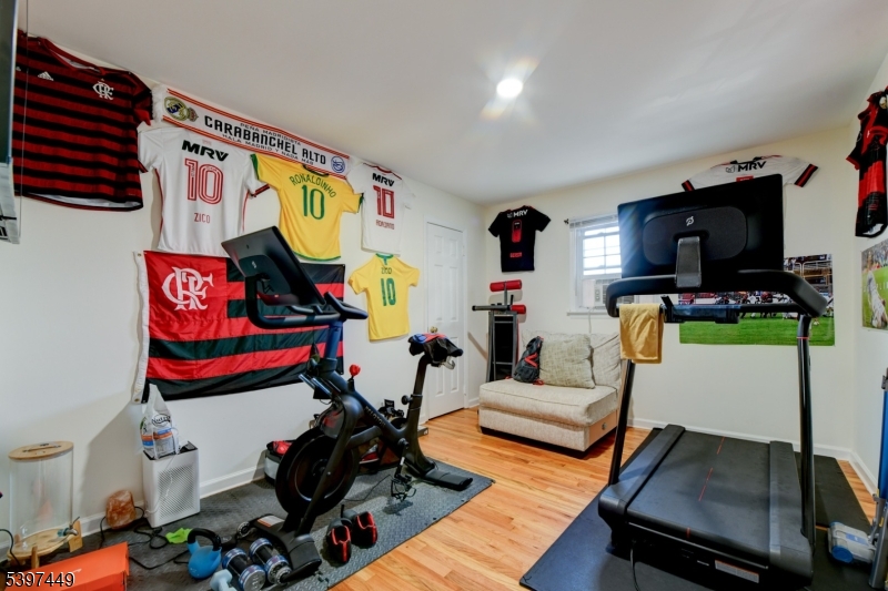 8 Sailer Court Elizabeth, NJ 07201 - Photo 18 of 27 a living room with furniture and a flat screen tv