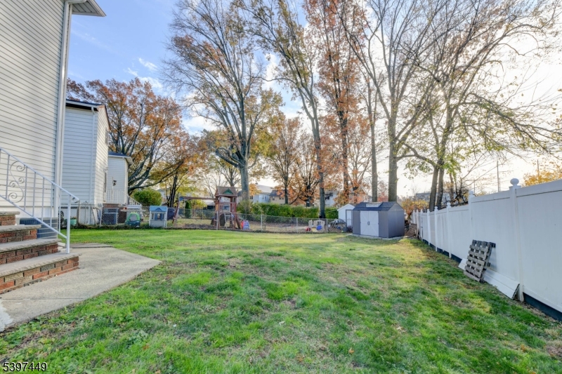 8 Sailer Court Elizabeth, NJ 07201 - Photo 23 of 27 a view of a house with a big yard and large trees