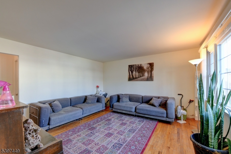 8 Sailer Court Elizabeth, NJ 07201 - Photo 3 of 27 a living room with furniture and a potted plant