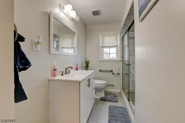 a bathroom with a sink toilet and a window