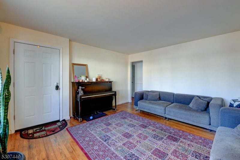 8 Sailer Court Elizabeth, NJ 07201 - Photo 8 of 27 a living room with furniture and a rug