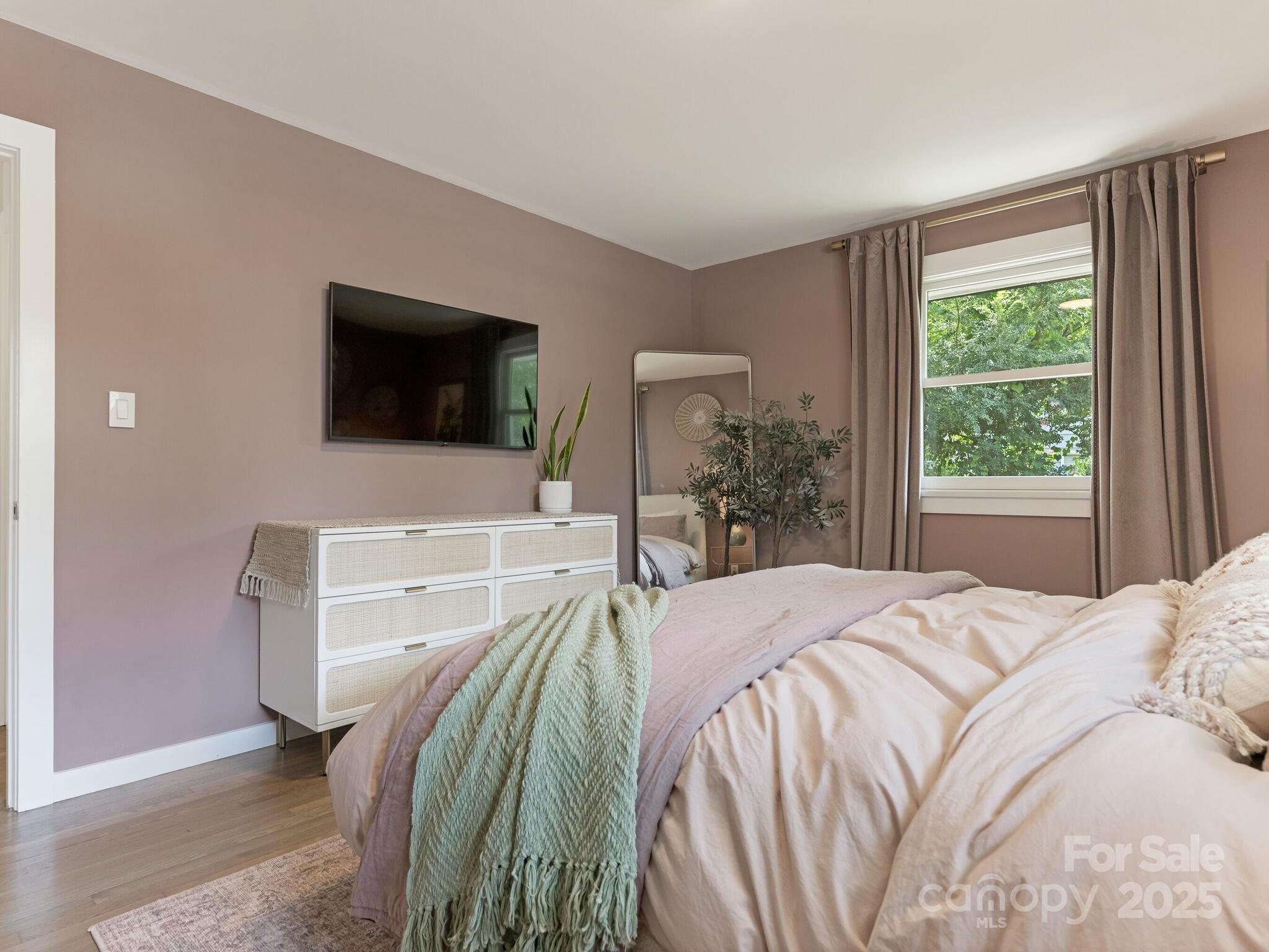 4901 Murrayhill Road Charlotte, NC 28209 - Photo 11 of 28 a bedroom with a bed and a flat screen tv