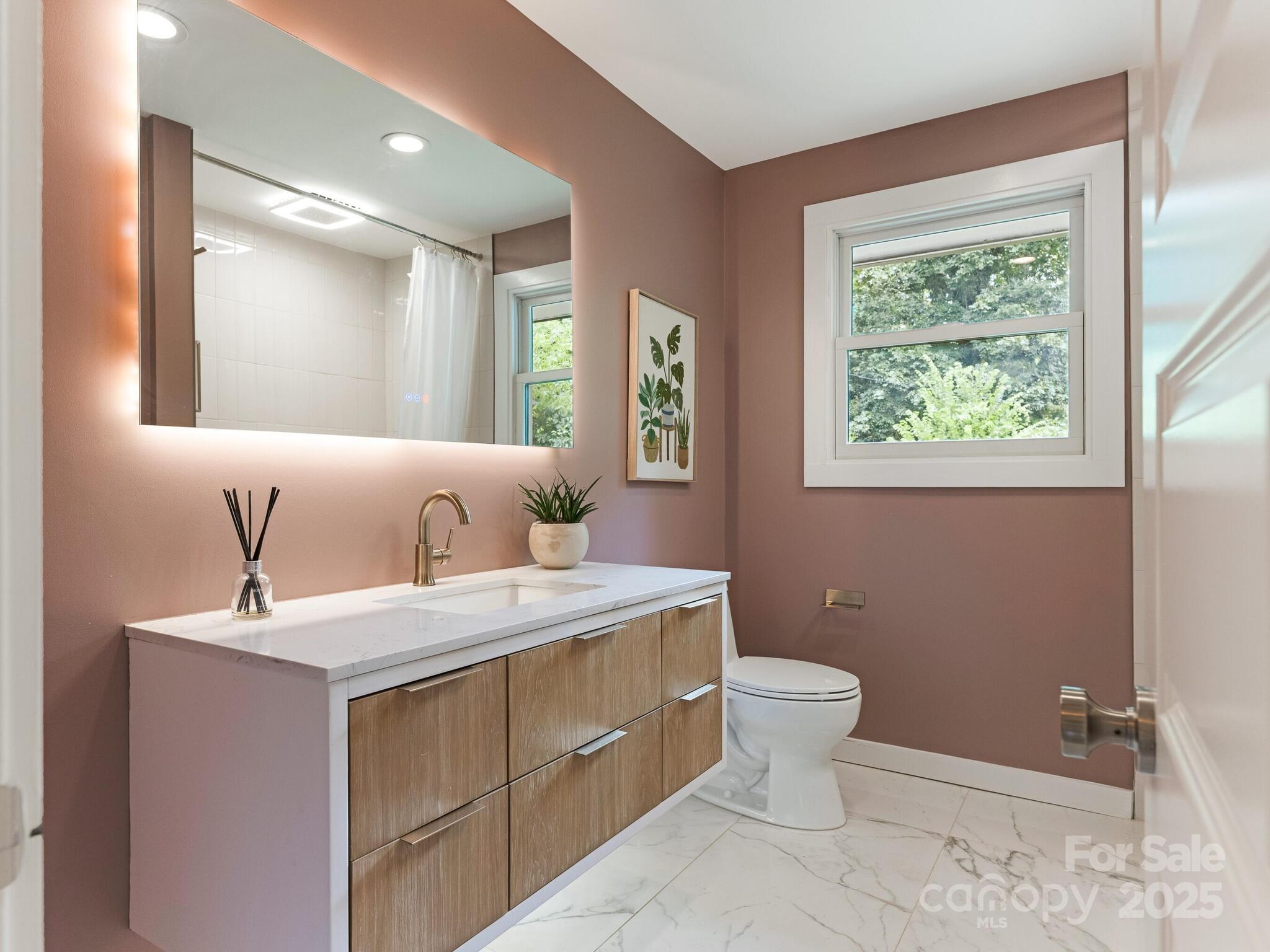 4901 Murrayhill Road Charlotte, NC 28209 - Photo 13 of 28 a bathroom with a sink toilet and window