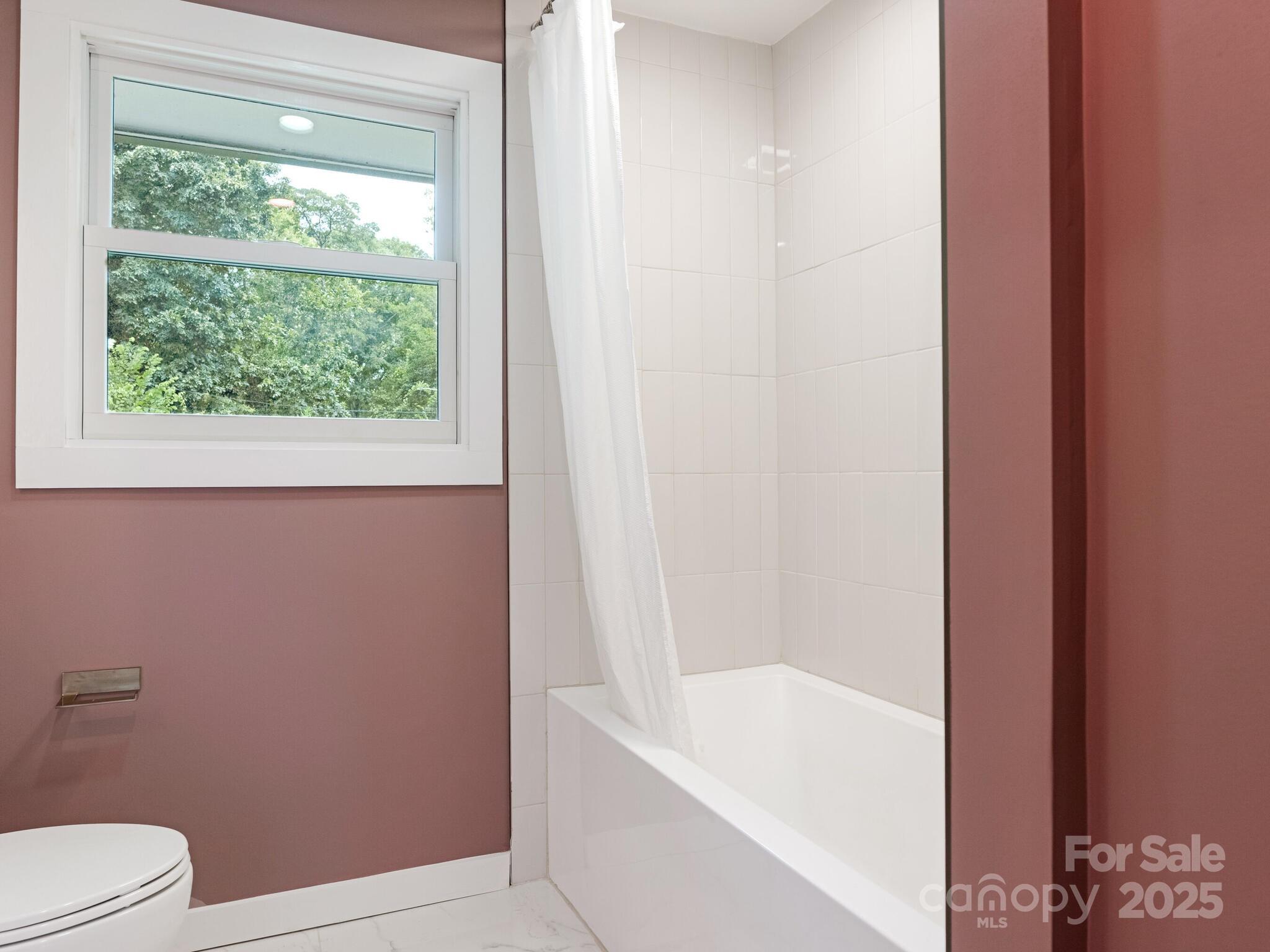 4901 Murrayhill Road Charlotte, NC 28209 - Photo 14 of 28 a bathroom with a bathtub and window