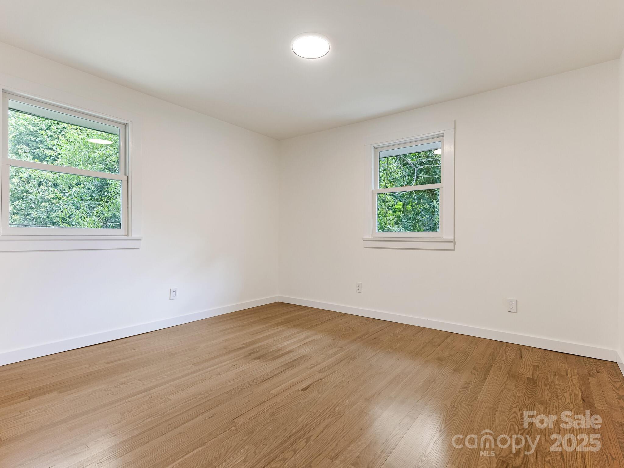 4901 Murrayhill Road Charlotte, NC 28209 - Photo 15 of 28 an empty room with wooden floor and windows