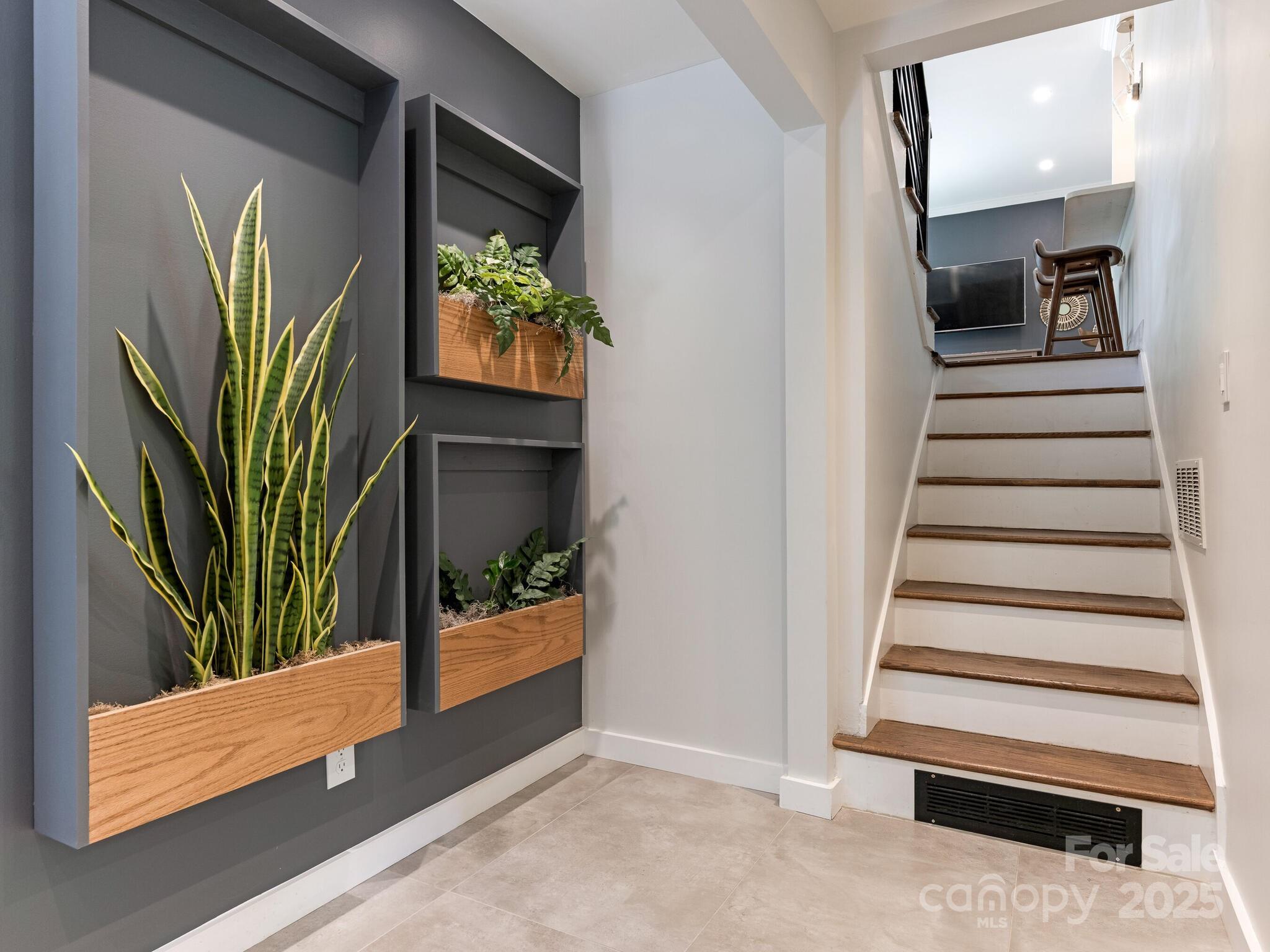 4901 Murrayhill Road Charlotte, NC 28209 - Photo 16 of 28 a view of a hallway with wooden floor and windows