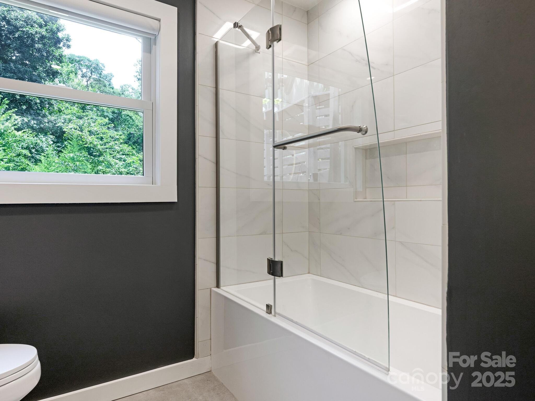 4901 Murrayhill Road Charlotte, NC 28209 - Photo 18 of 28 a bathroom with a bathtub and a shower