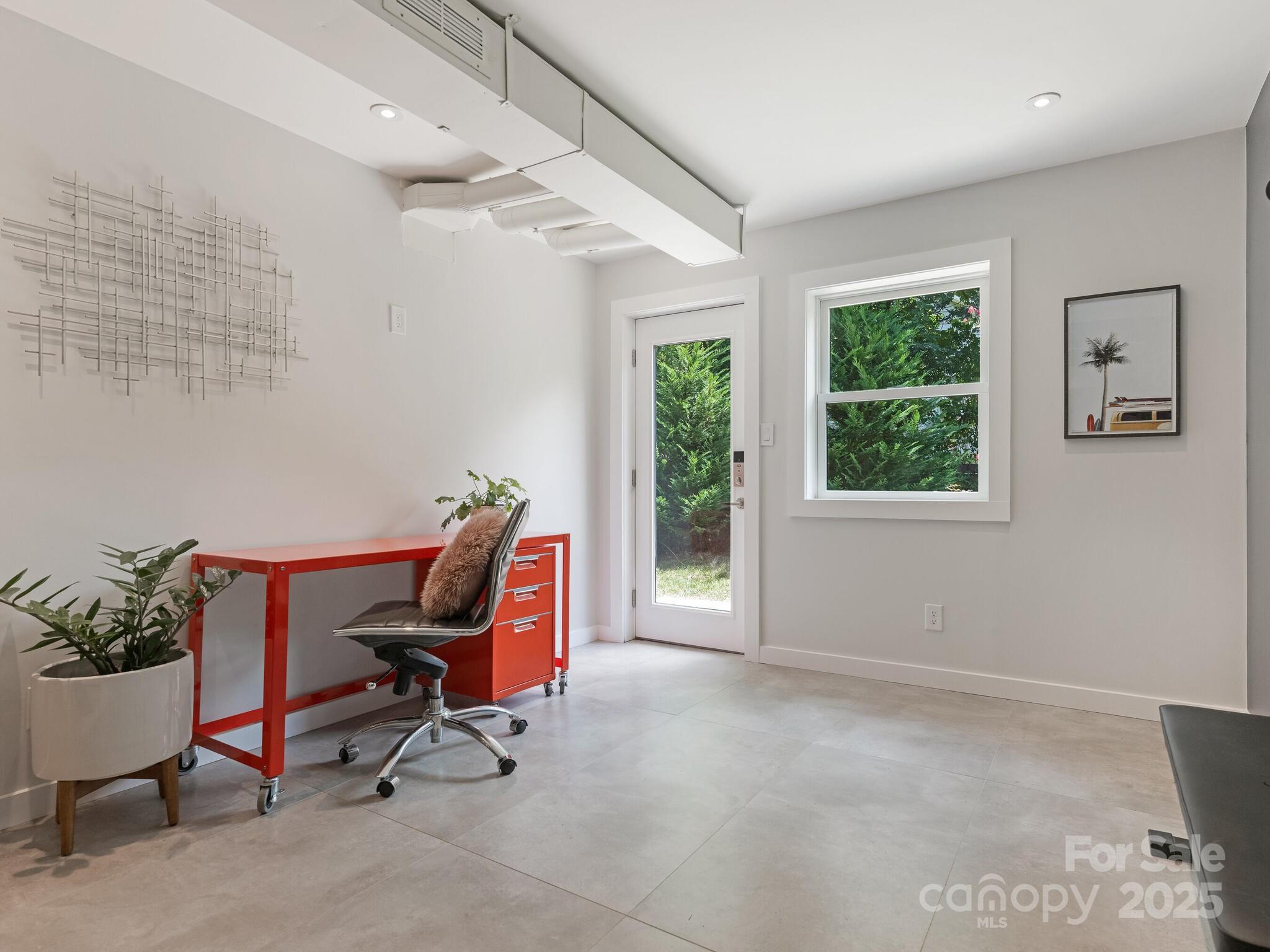 4901 Murrayhill Road Charlotte, NC 28209 - Photo 20 of 28 a view of a workspace with furniture and a window
