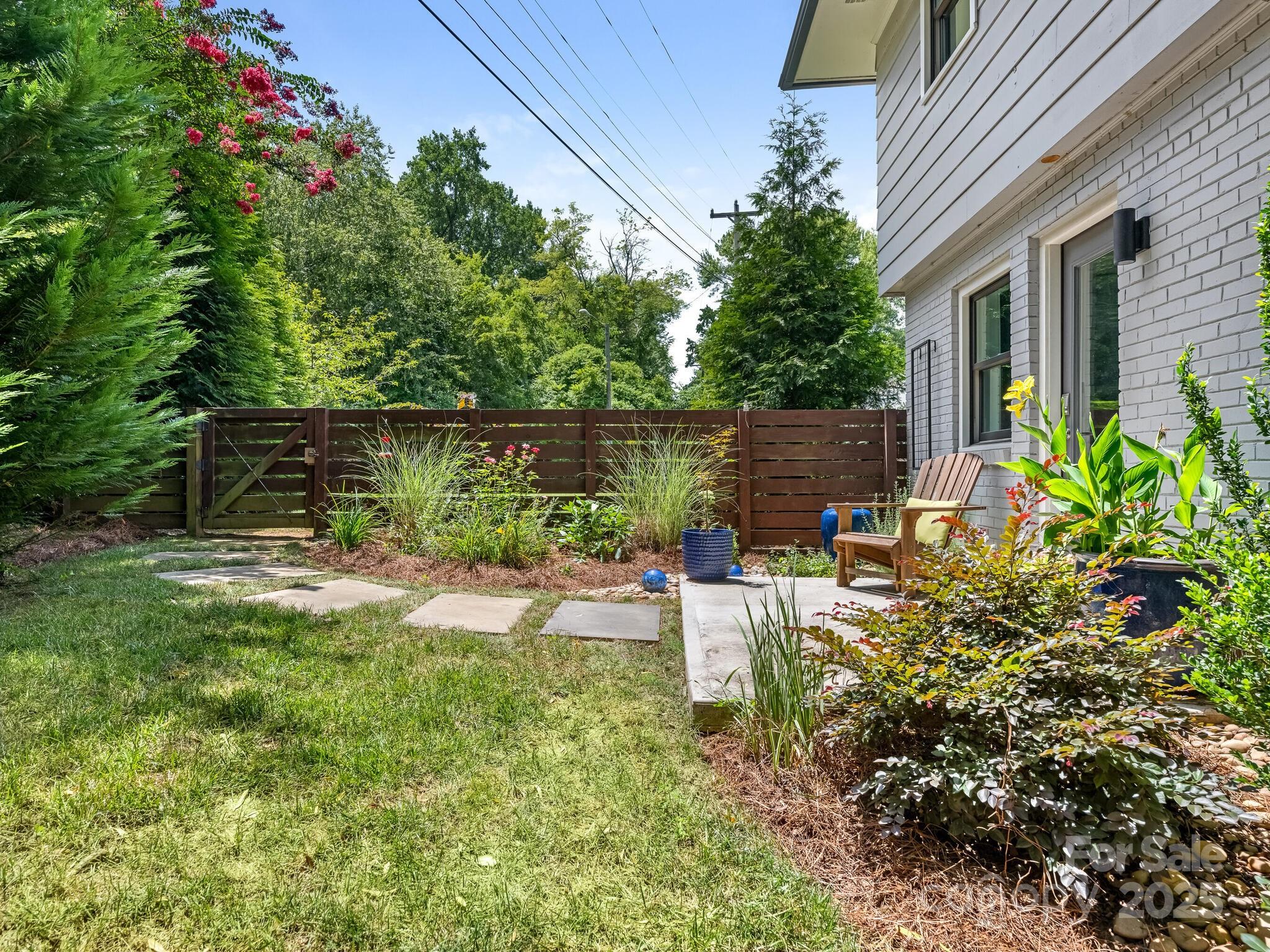 4901 Murrayhill Road Charlotte, NC 28209 - Photo 22 of 28 a view of a chair and table in the garden
