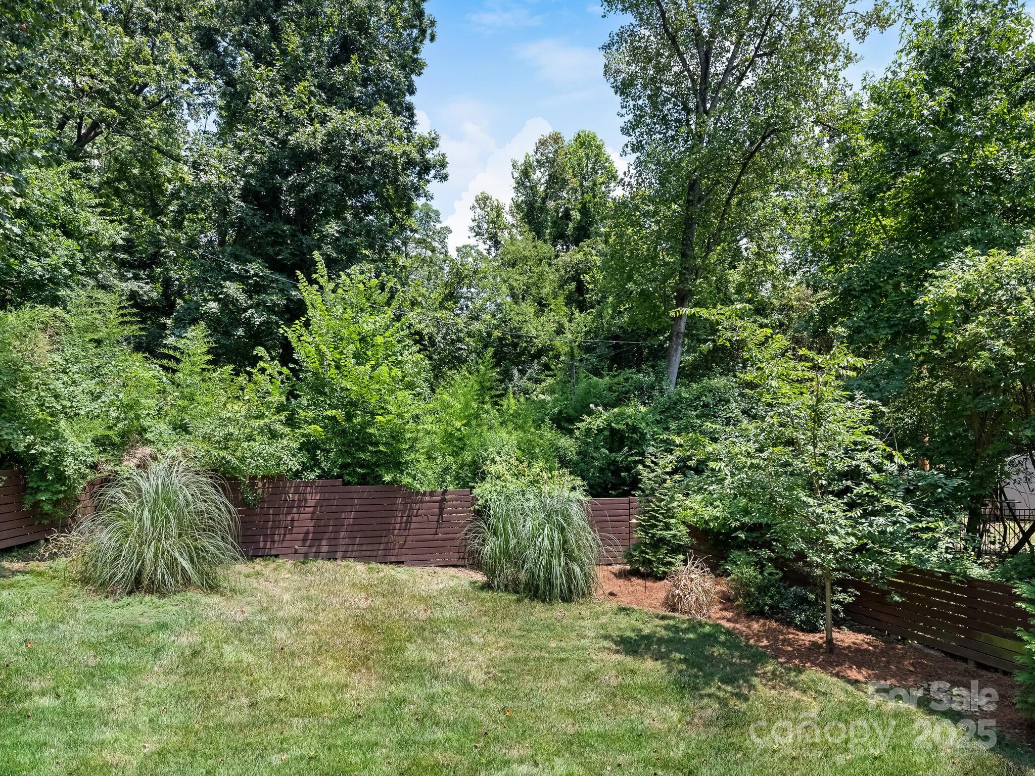 4901 Murrayhill Road Charlotte, NC 28209 - Photo 27 of 28 a backyard of a house with lots of green space